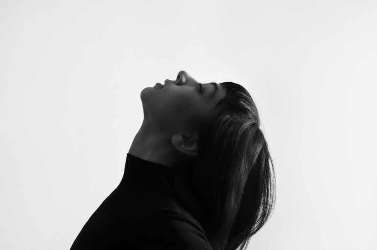 female grayscale photo facing upward