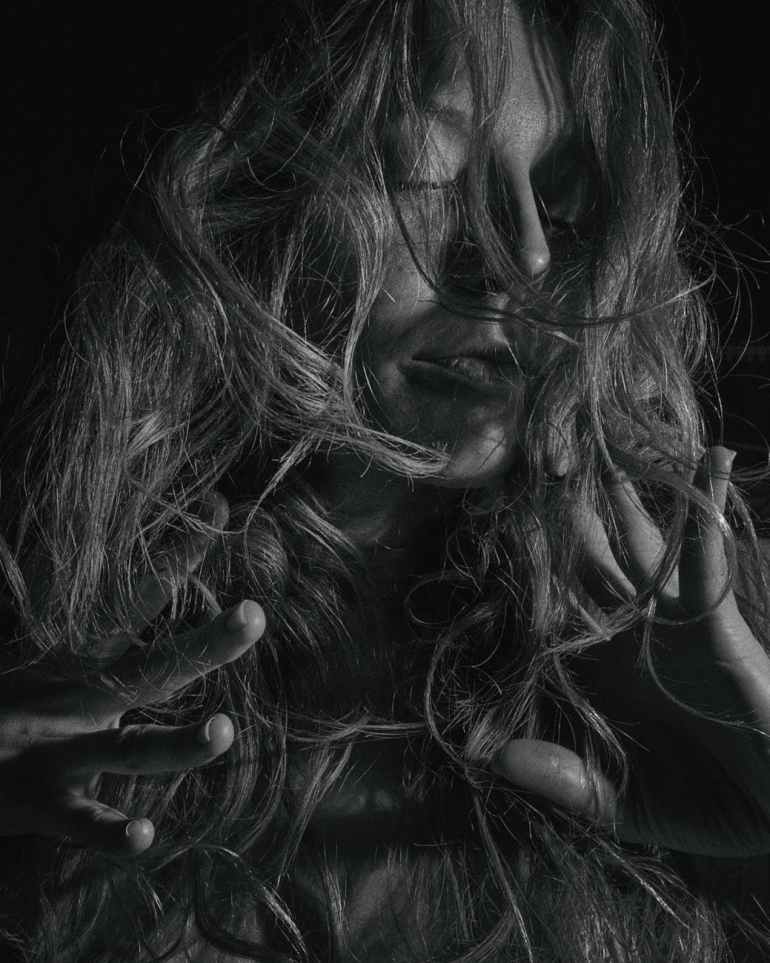 grayscale photo of woman with hair on her face