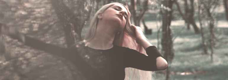 woman wearing black long sleeved shirt near trees