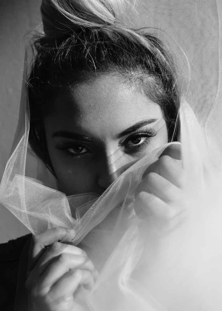 grayscale photography of woman covering her mouth