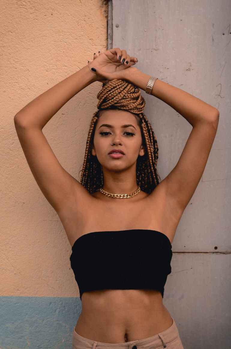 woman leaning on gray wall