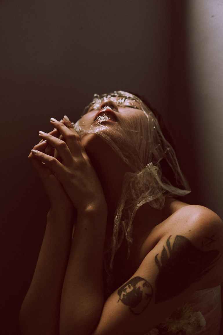 photo of woman s face covered with plastic