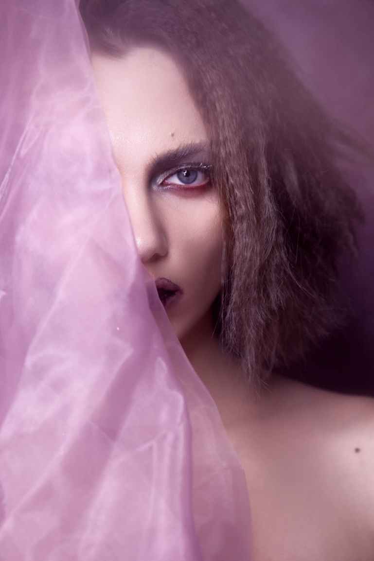 close up photo of woman holding textile