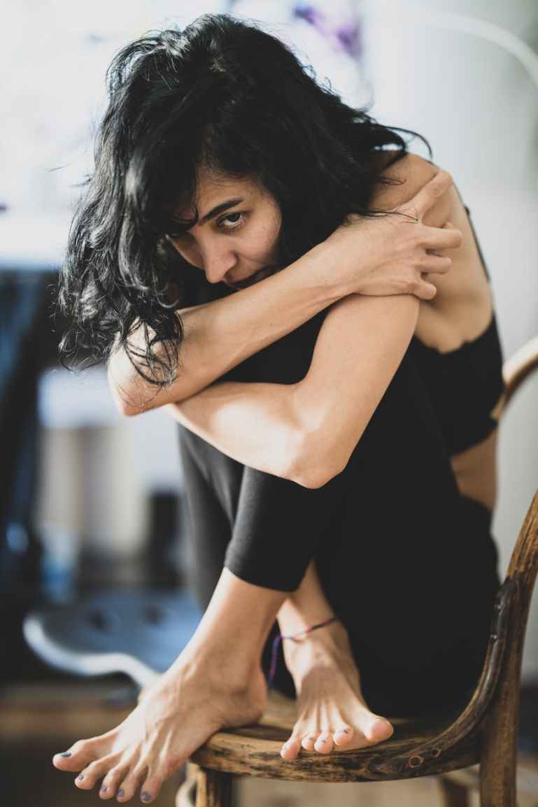 woman sitting on brown ratan chair