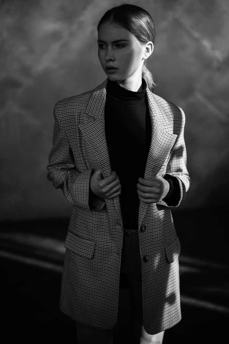 woman in black and white striped blazer