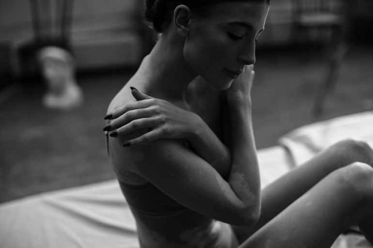 photo of a woman covering her body with two hands