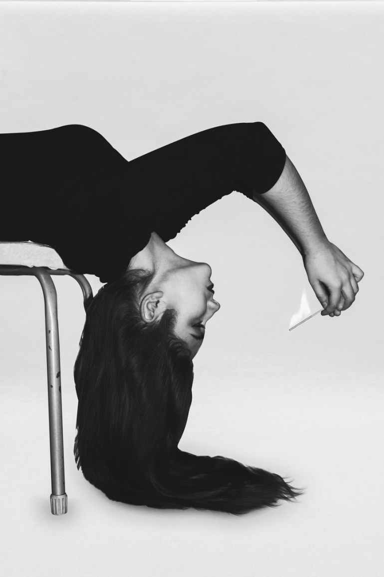 woman in black long sleeve shirt bending on chair