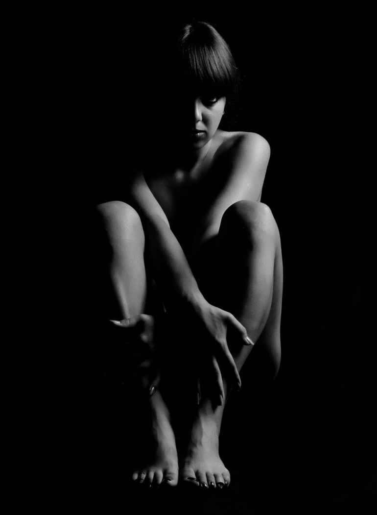 grayscale photography of woman inside dark room