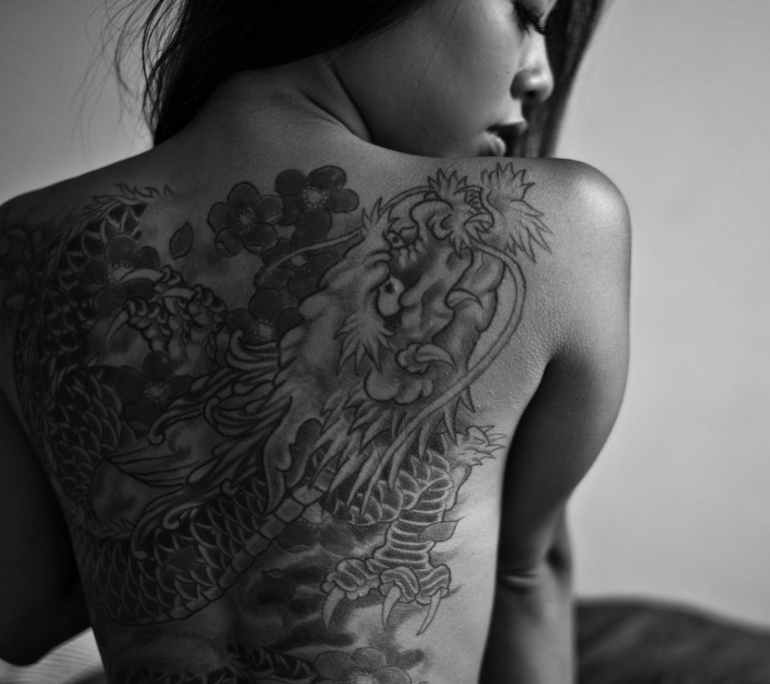 monochrome photo of tattooed woman