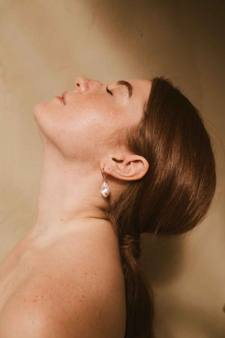 woman wearing silver stud earring