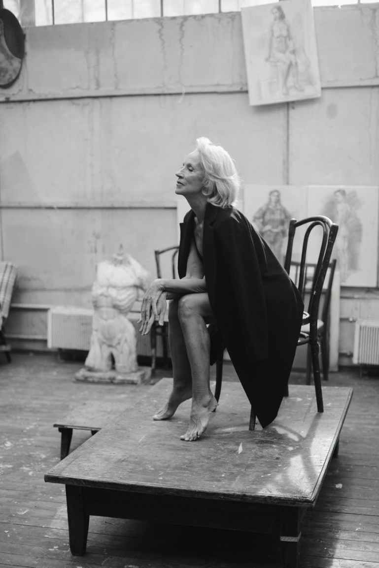 woman in black dress sitting on black chair