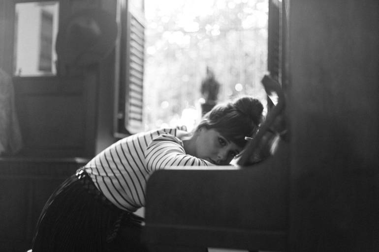 grayscale photography of woman in white and black stripe crew neck top